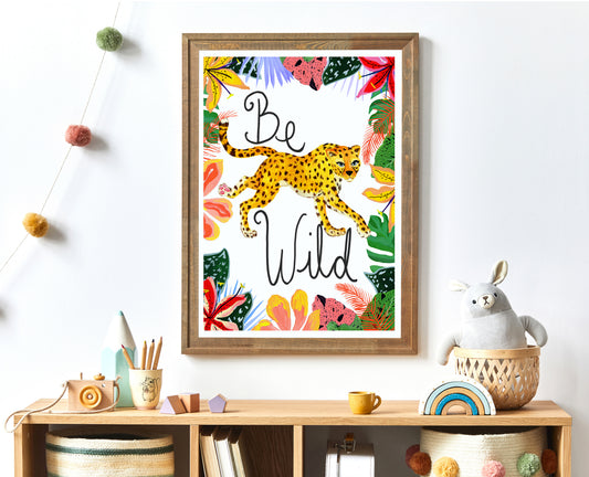 Framed artwork with a leopard and 'Be Wild' text on a shelf with decorative items.
