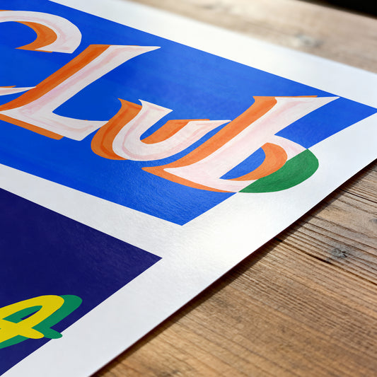 Colorful 'Club' sign on a wooden surface