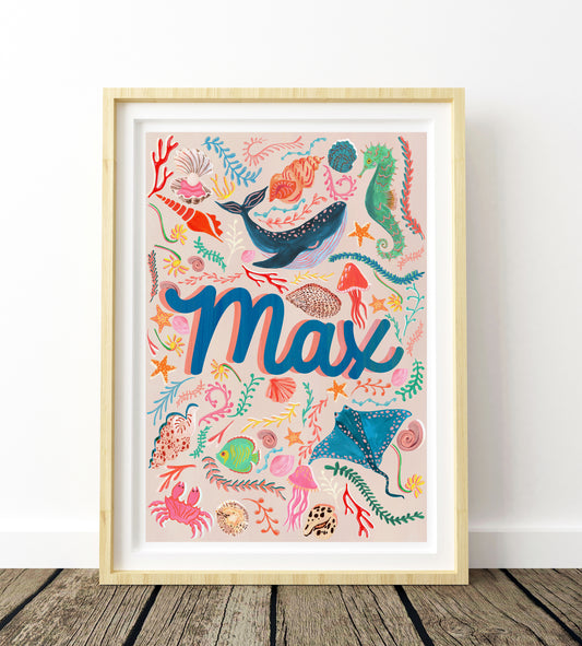 Framed artwork with colorful sea-themed design and the name 'Max' on a white wall.