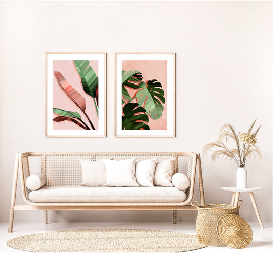 Living room with a wicker sofa, decorative pillows, and framed leaf prints on the wall.