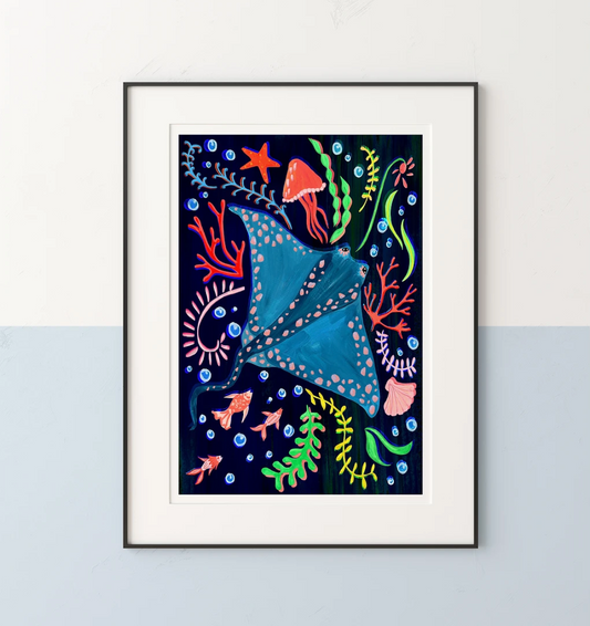 Framed artwork of a colorful stingray and underwater plants on a white wall.