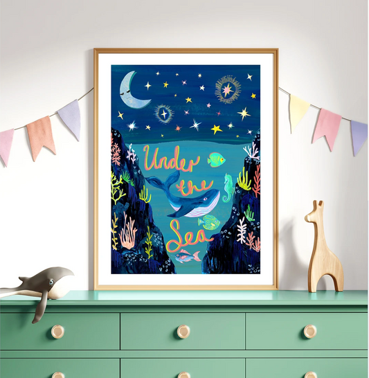 Framed artwork titled 'Under the Sea' on a dresser with decorative elements.