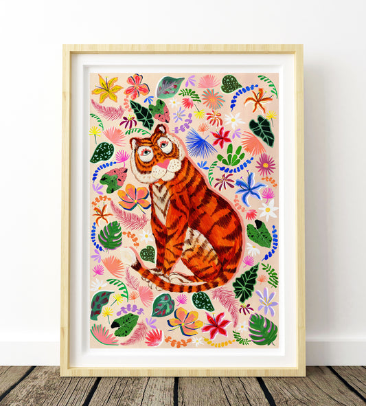 Framed artwork of a tiger surrounded by colorful flowers and leaves on a white wall.