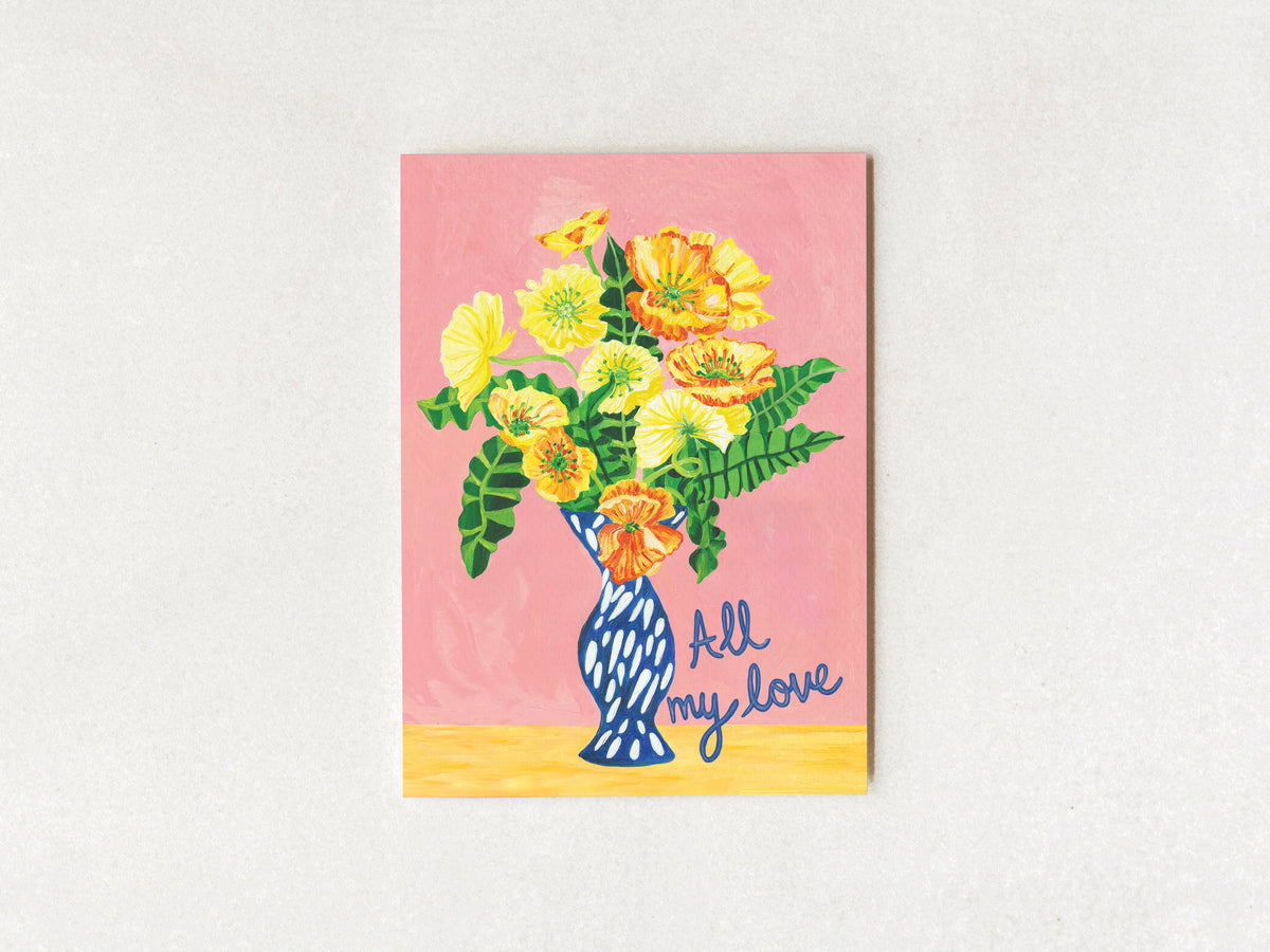 A square art print or card featuring a colorful illustration of yellow and orange flowers in a blue patterned vase against a pink background, with the words 'All my love' in blue script at the bottom right, displayed on a light textured wall.