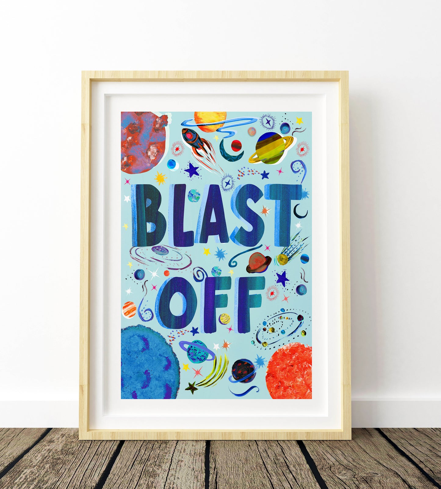 Framed children's poster with 'BLAST OFF' text and space-themed graphics on a light blue background.