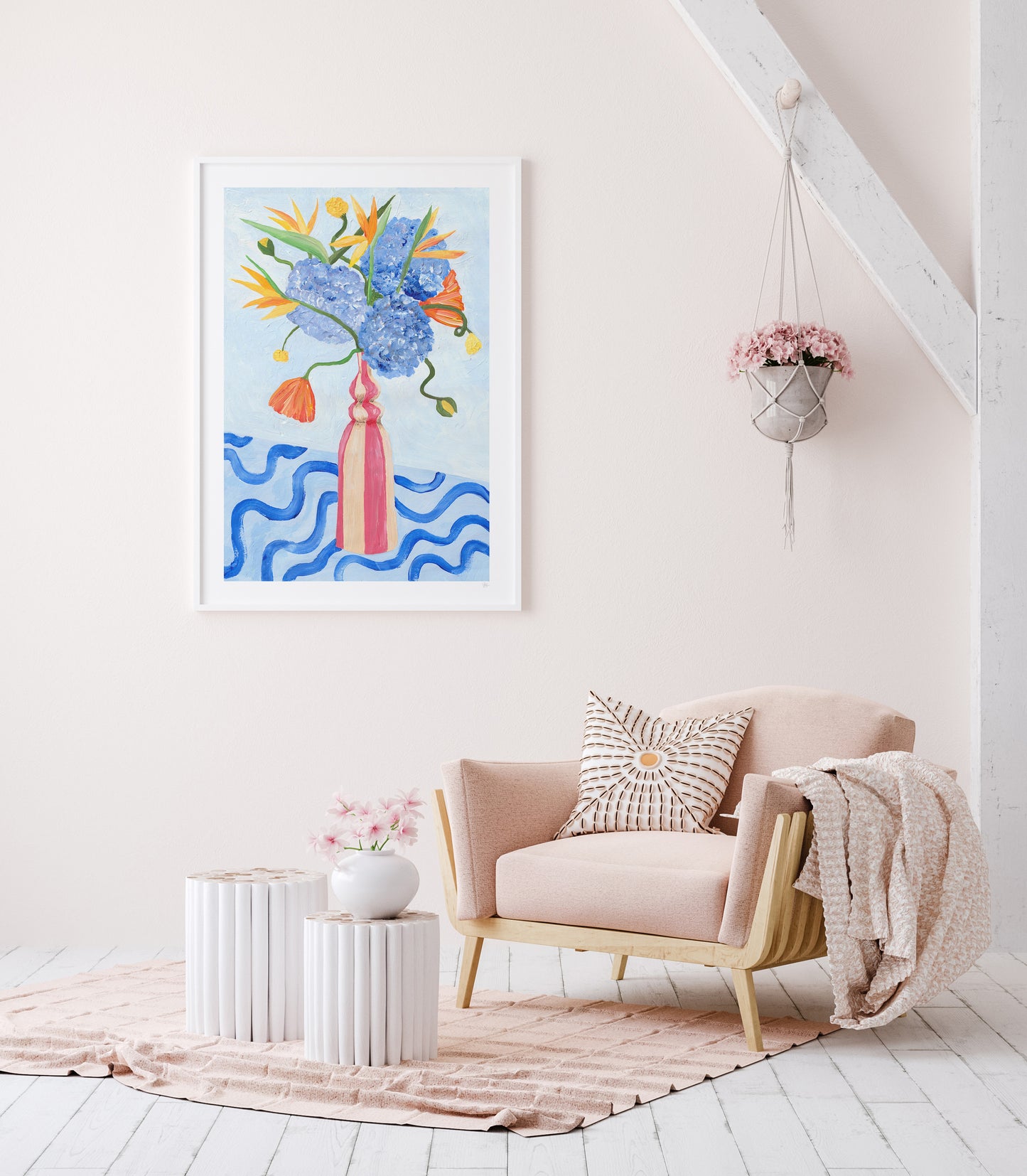 Modern living room with a pink armchair, abstract artwork, and decorative elements.