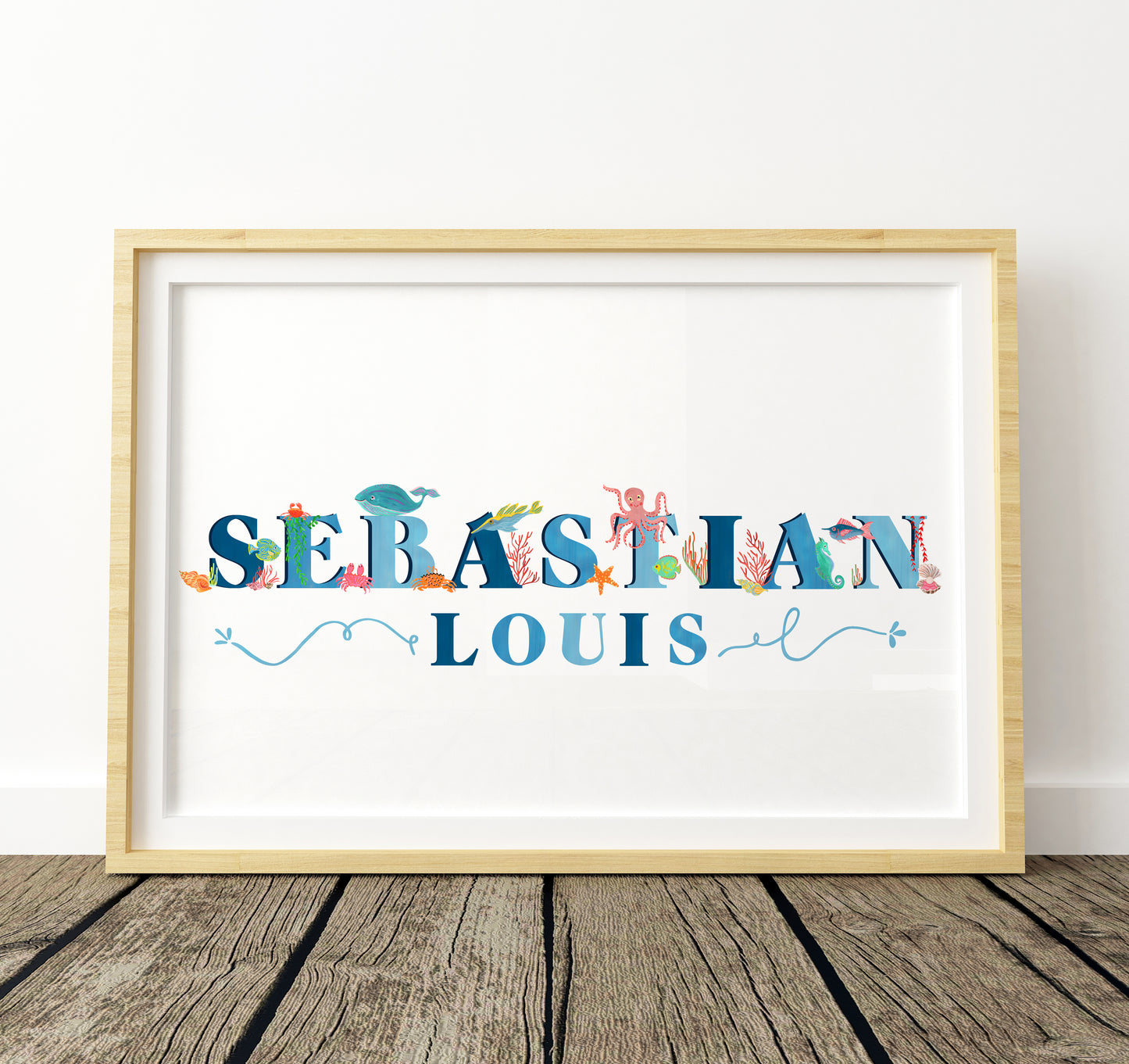 Framed print with 'SEBASTIAN LOUIS' in colorful letters and sea animal illustrations on a white background