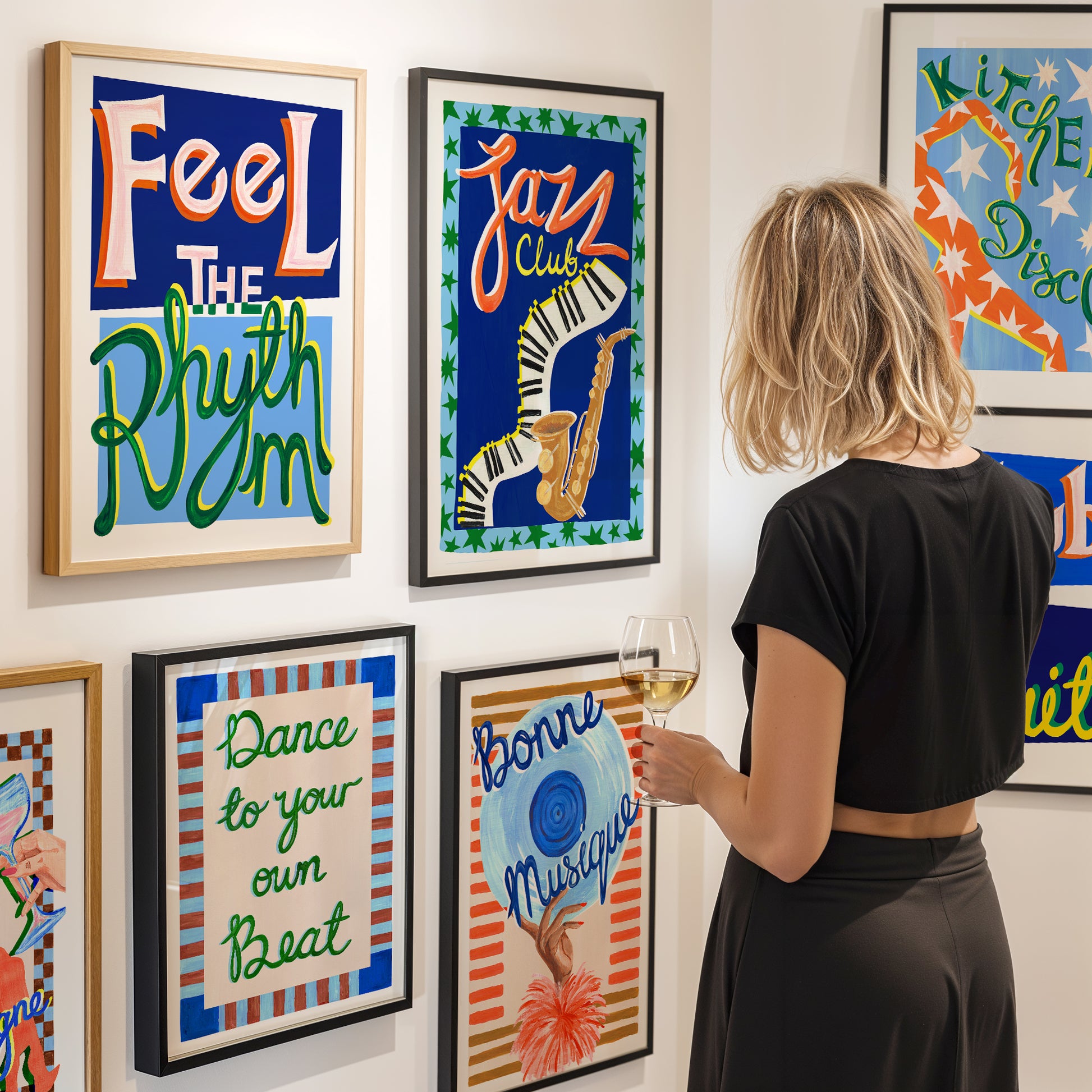 Woman standing in front of colorful framed art on a wall