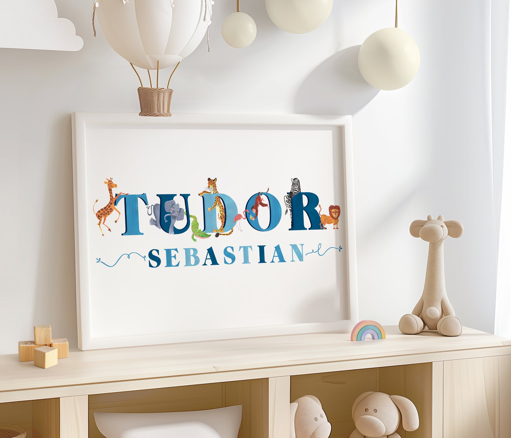 Framed name artwork with safaari animal illustrations on a shelf with toys and decorations.