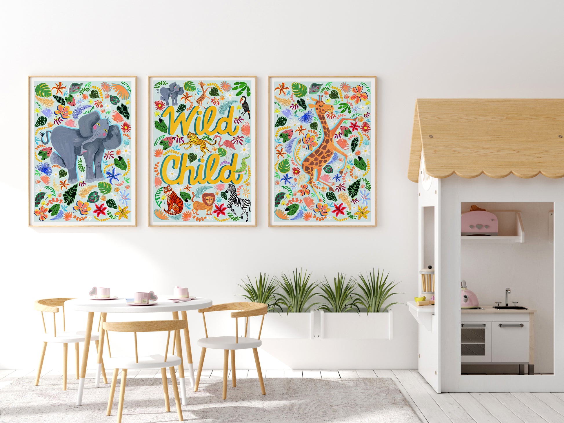 A white nursery with colourful Safari animal prints on the wall of an elephant annd a giraffe and a yellow lettered Wild Child design