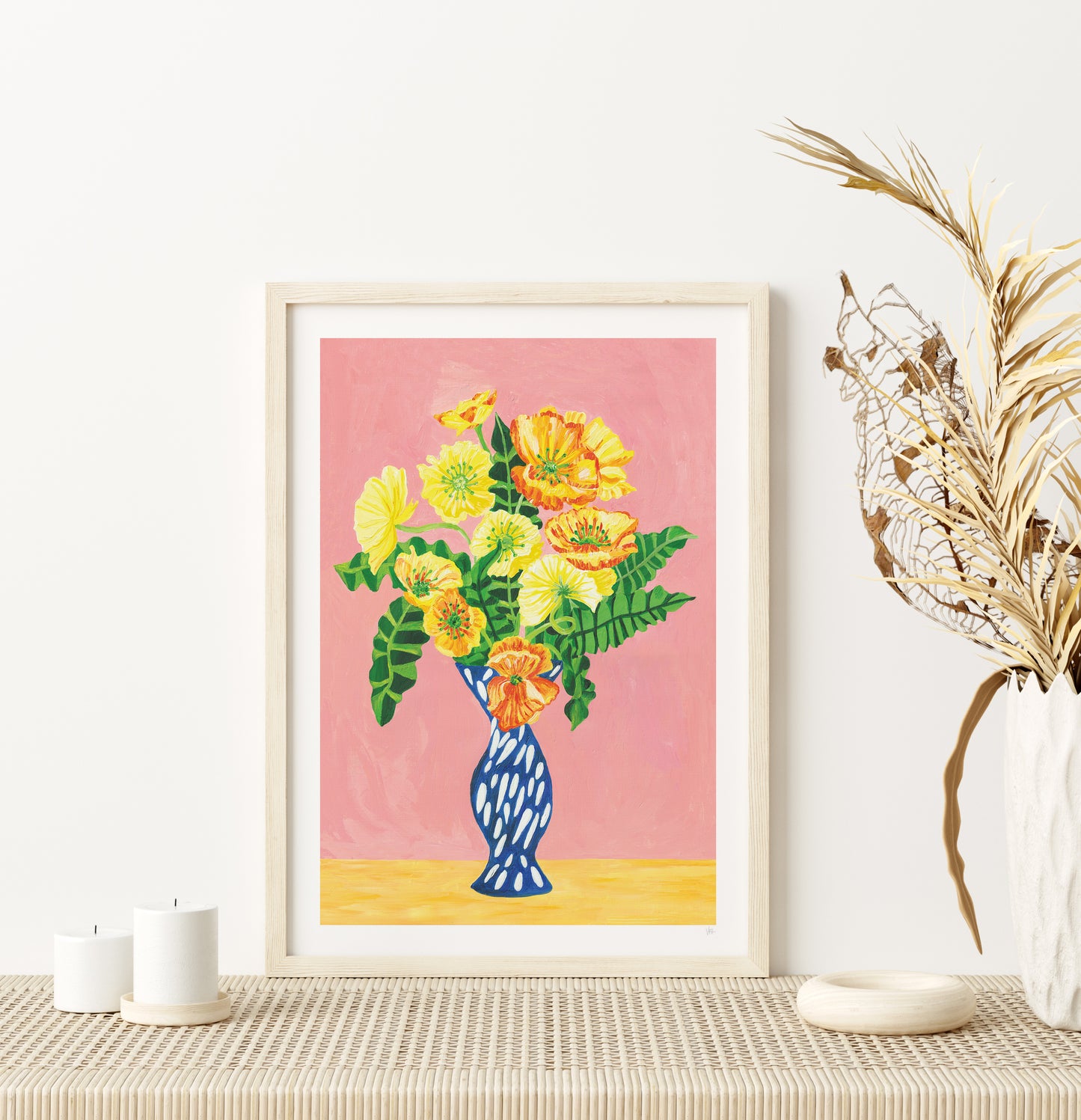 Framed floral artwork on a wall with decorative elements.