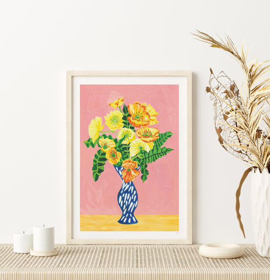 Framed floral artwork on a wall with decorative elements.
