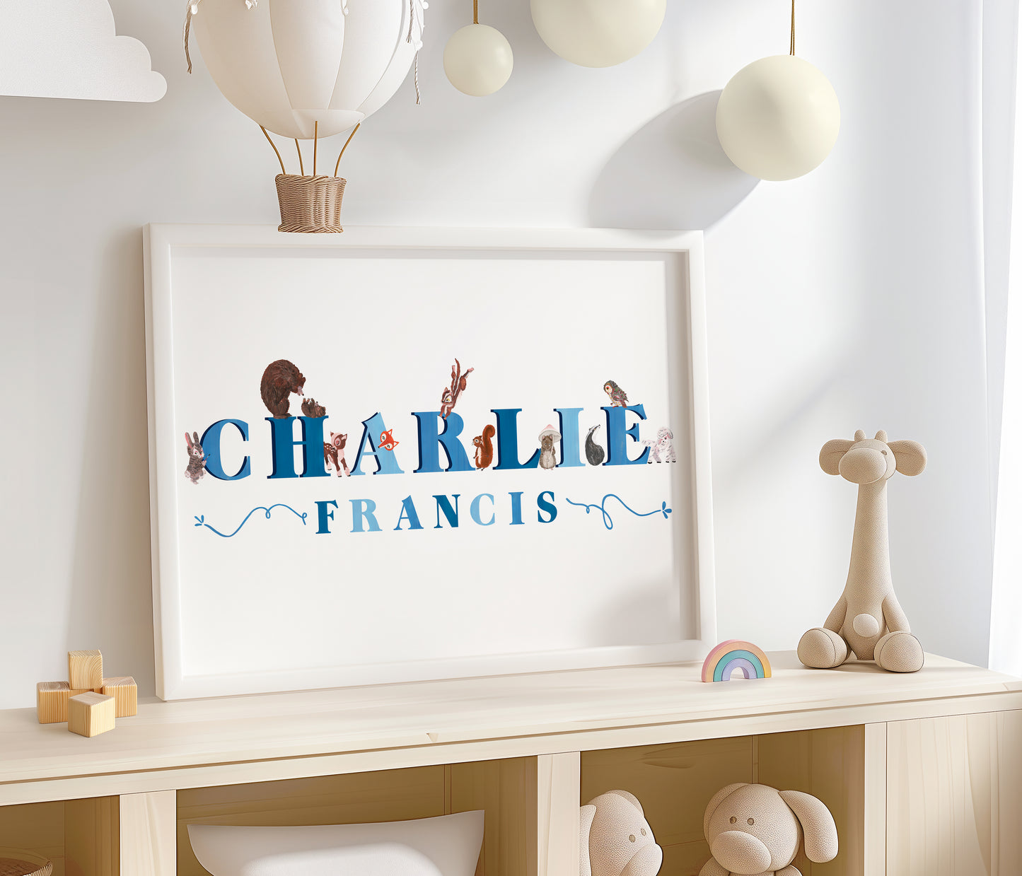 Framed artwork with 'CHARLIE FRANCIS' on a shelf with toys and decorations.