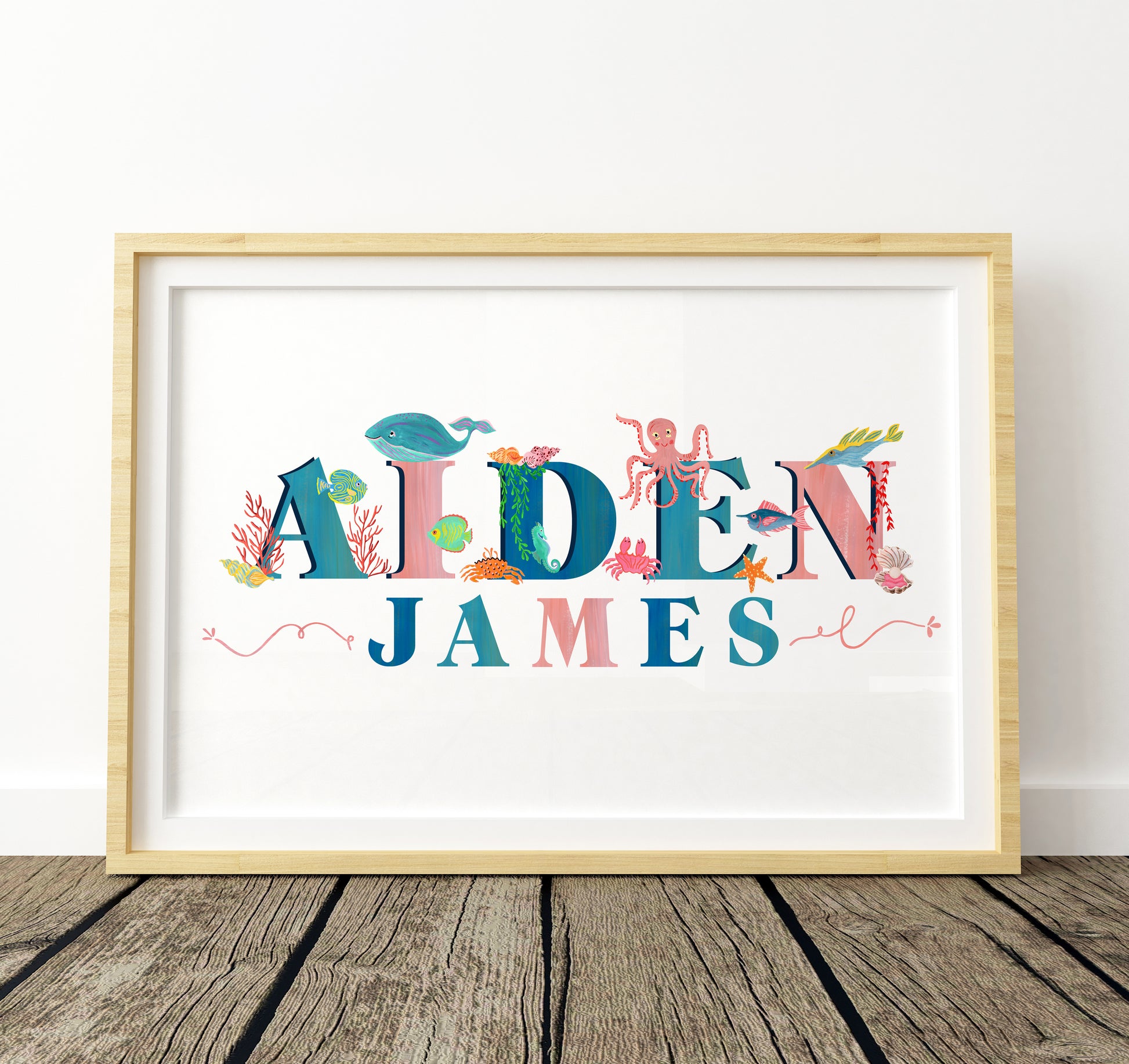 Framed children's name art with colorful letters and sea-themed characters on a white background.