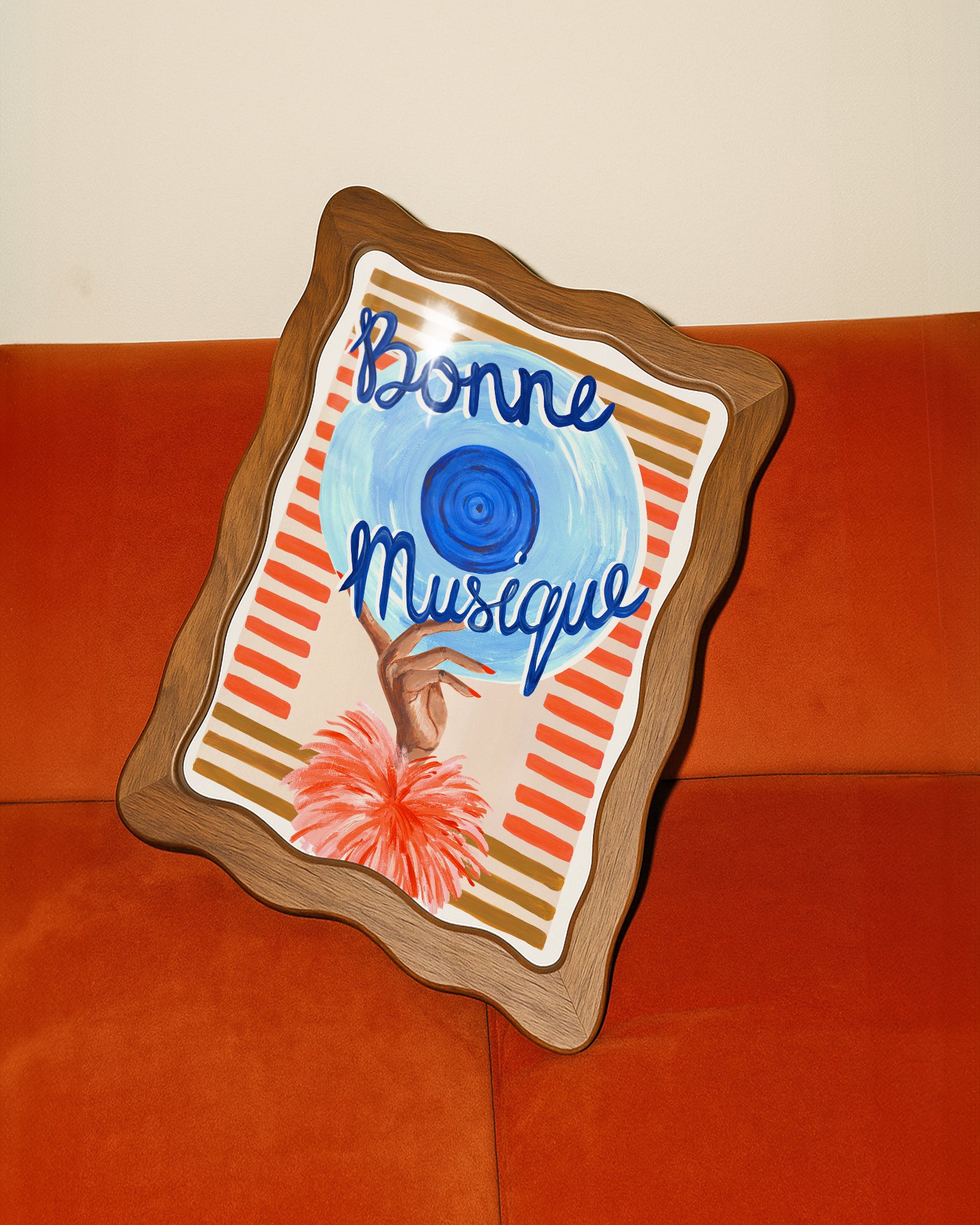 Decorative wall art with 'Bonne Musique' text on a wooden frame against an orange background.