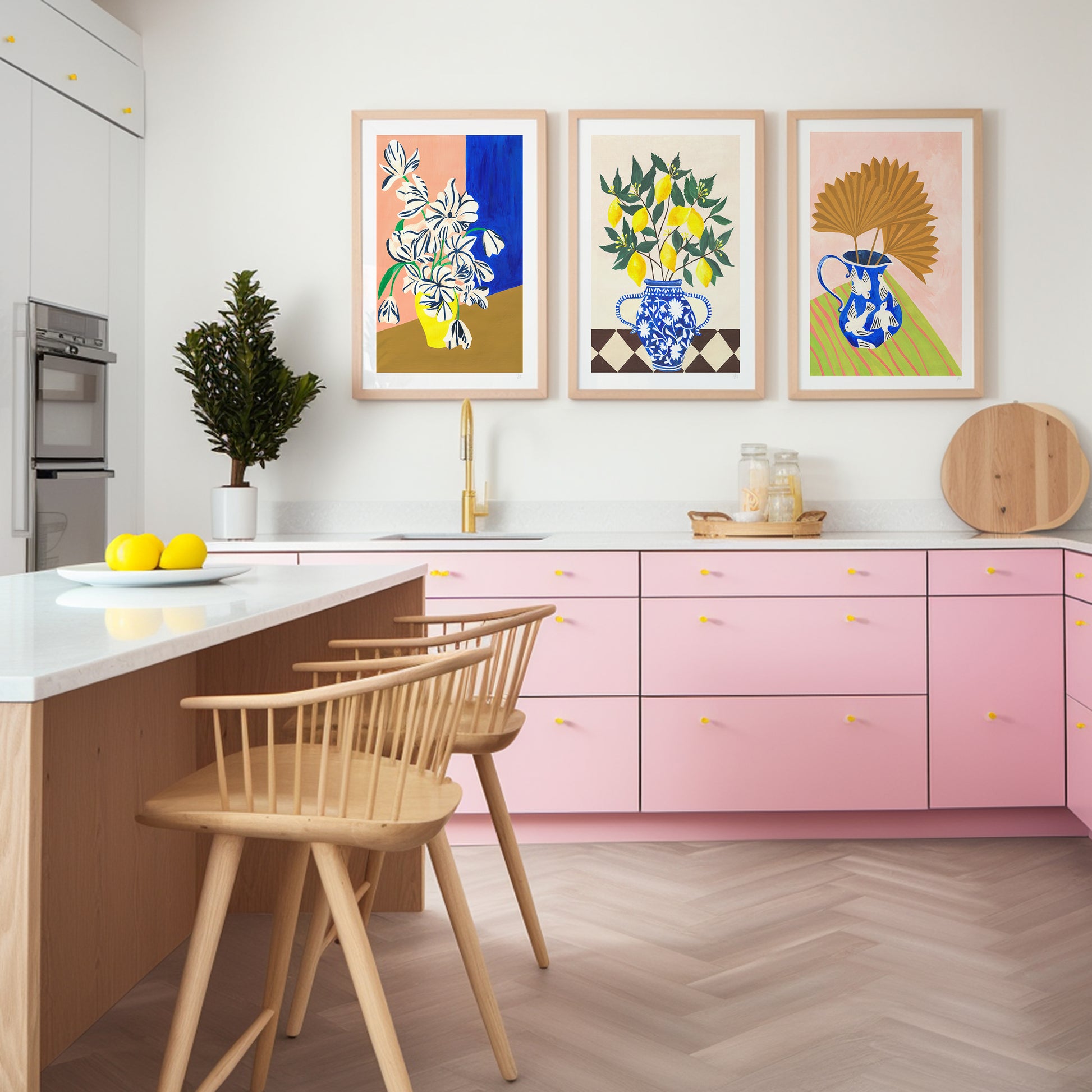 Modern kitchen with pink cabinets, wooden chairs, and colorful wall art.