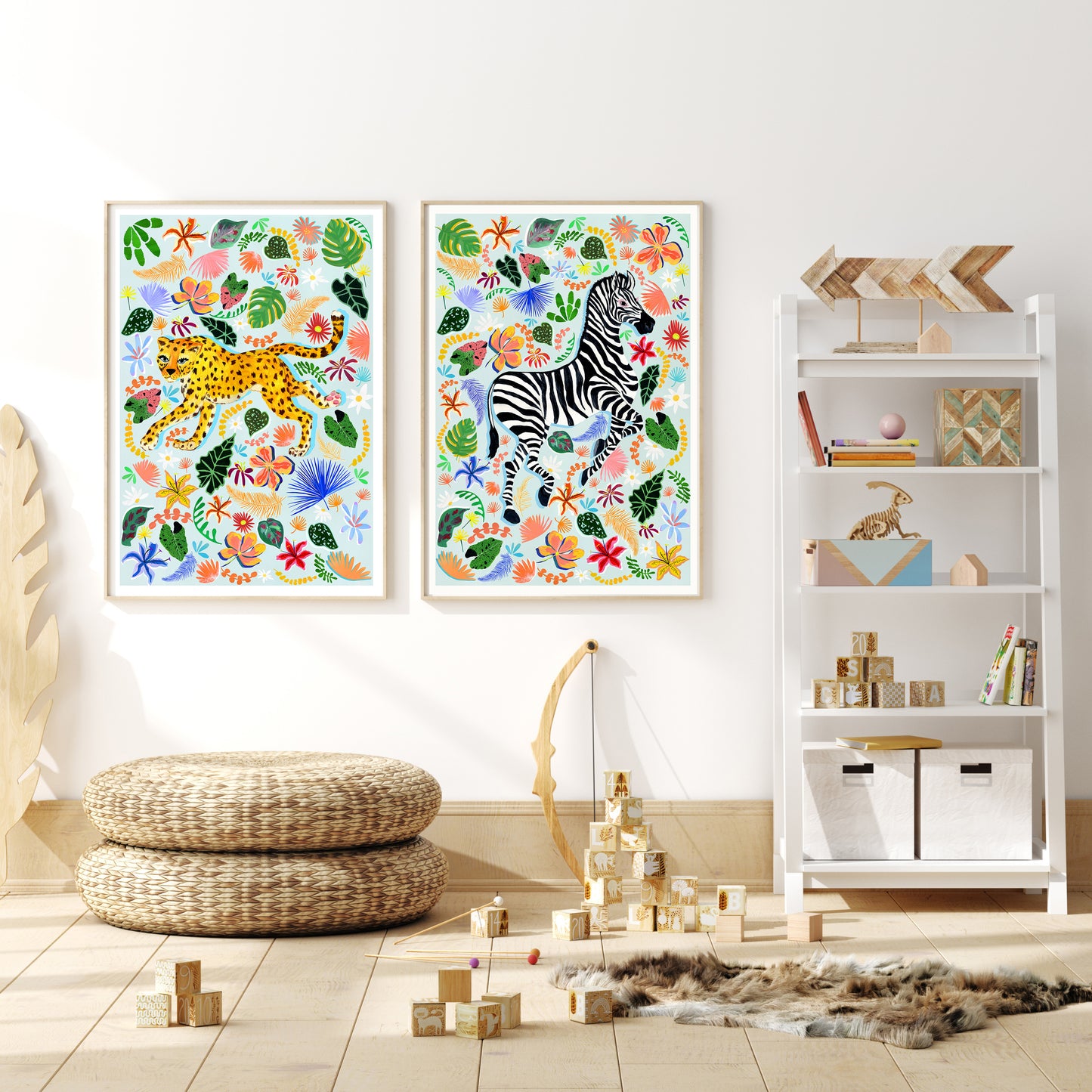 Colorful animal prints on a wall above a white shelf with toys and books.
