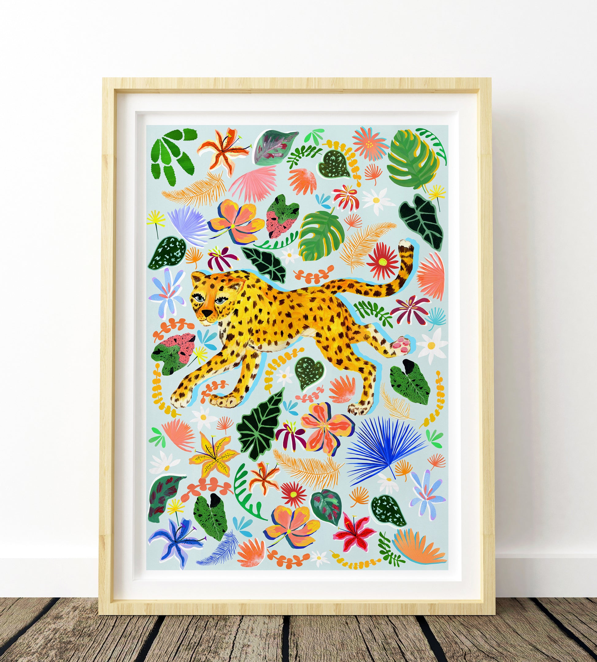Framed artwork of a colorful leopard and tropical plants on a white background