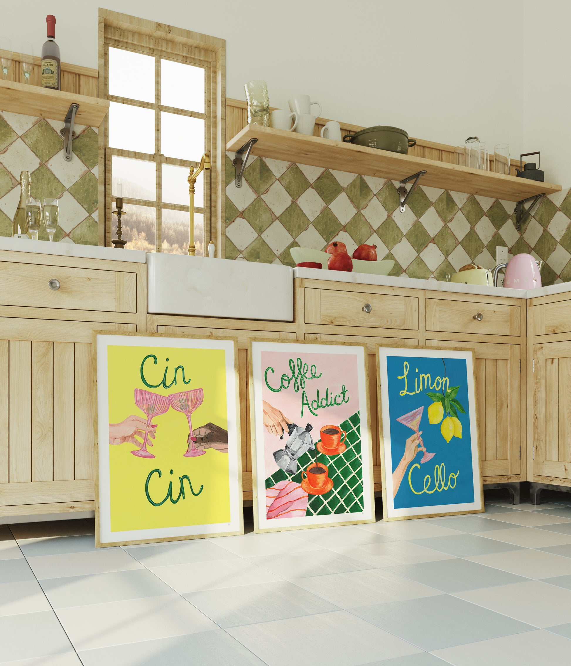 Three colorful posters on a kitchen floor with wooden cabinets and a window in the background.