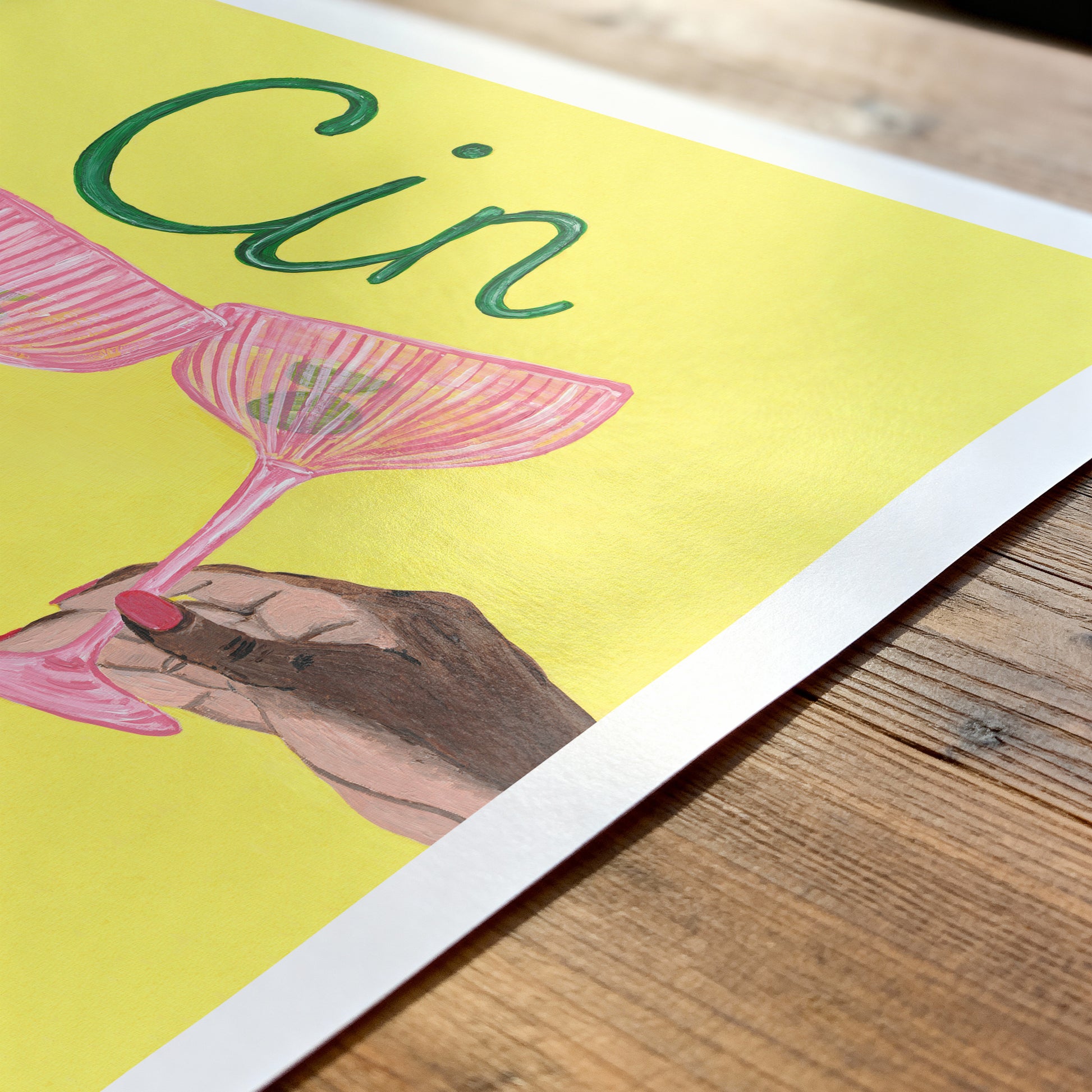 Illustration of a hand holding a pink cocktail glass with 'Cin' text on a yellow background.