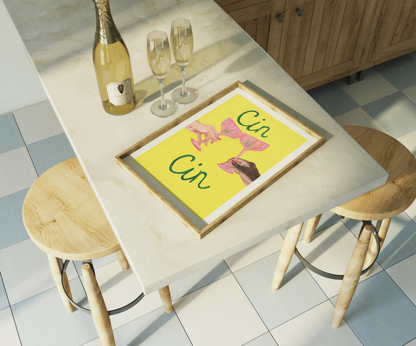 Dining table with a framed picture, champagne bottle, and glasses on a tiled floor.