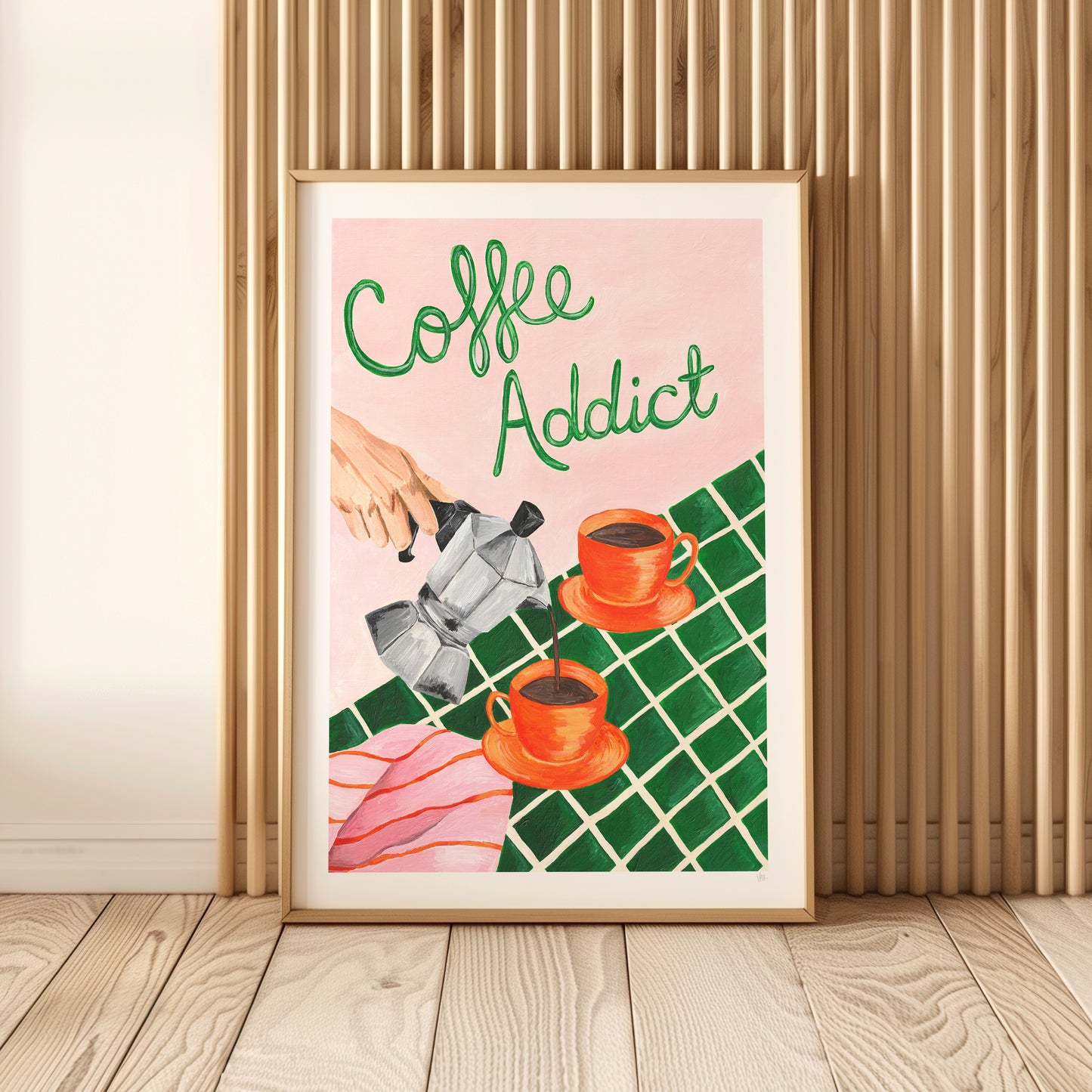 Framed artwork with 'Coffee Addict' text and coffee-themed illustration on a wall.