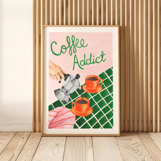 Framed artwork with 'Coffee Addict' text and coffee-themed illustration on a wall.