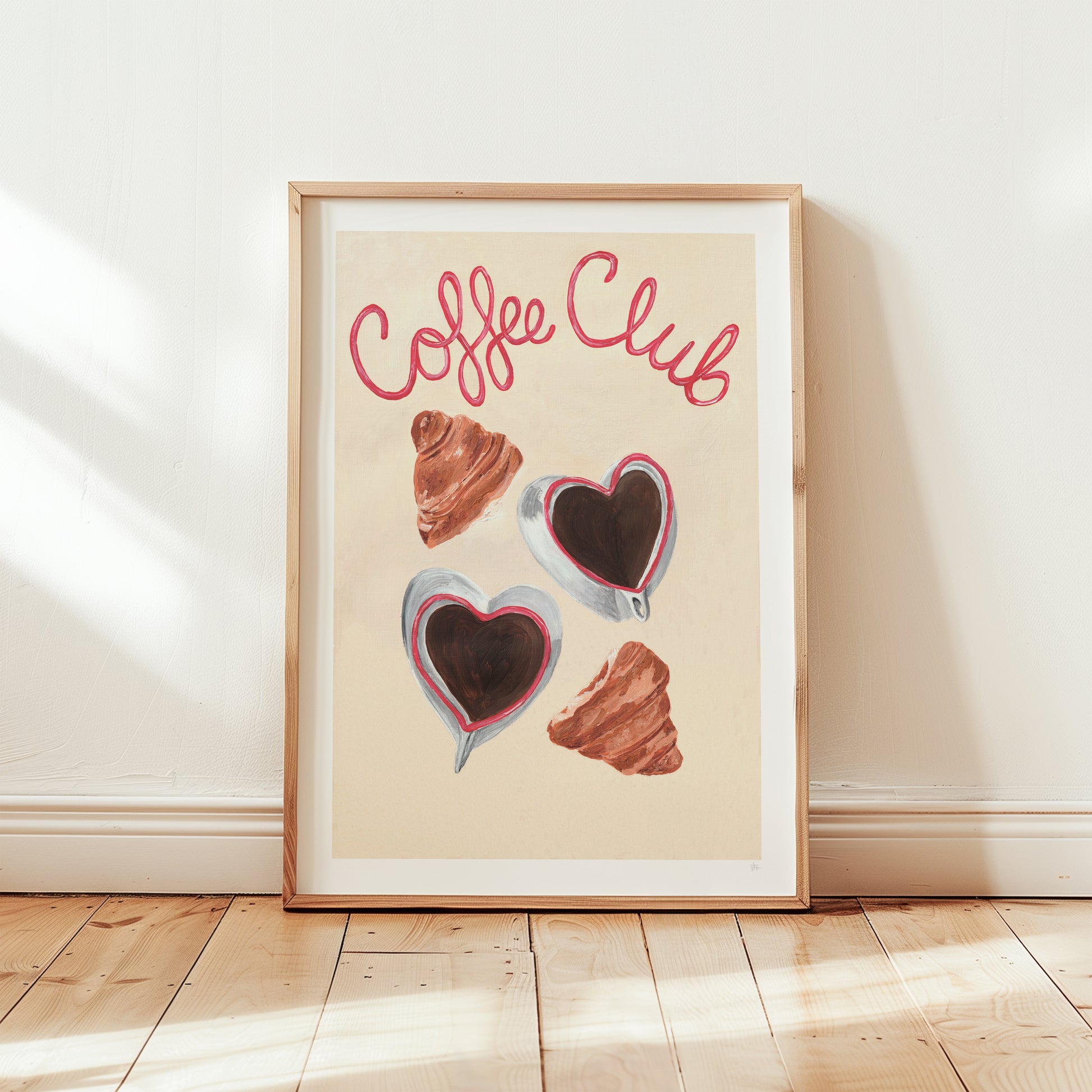 Framed artwork with 'Coffee Club' text and coffee-themed illustrations on a light background.