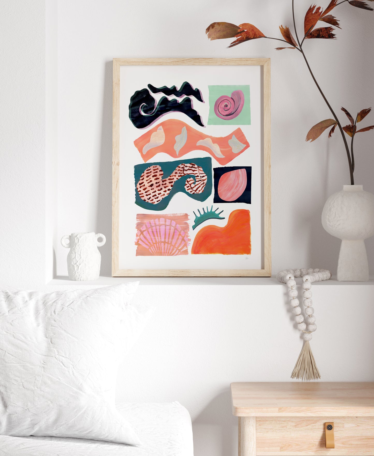 Framed abstract art print on a wall with decorative elements.