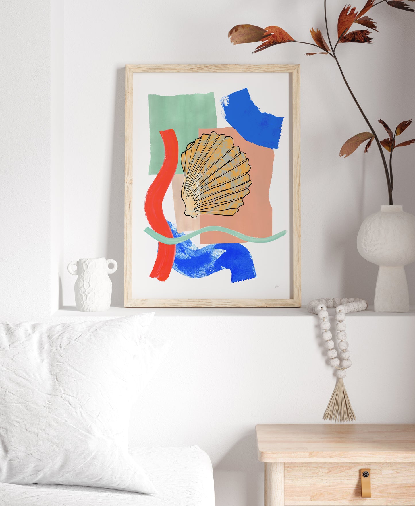 Abstract art print with colorful shapes on a wall in a living room.