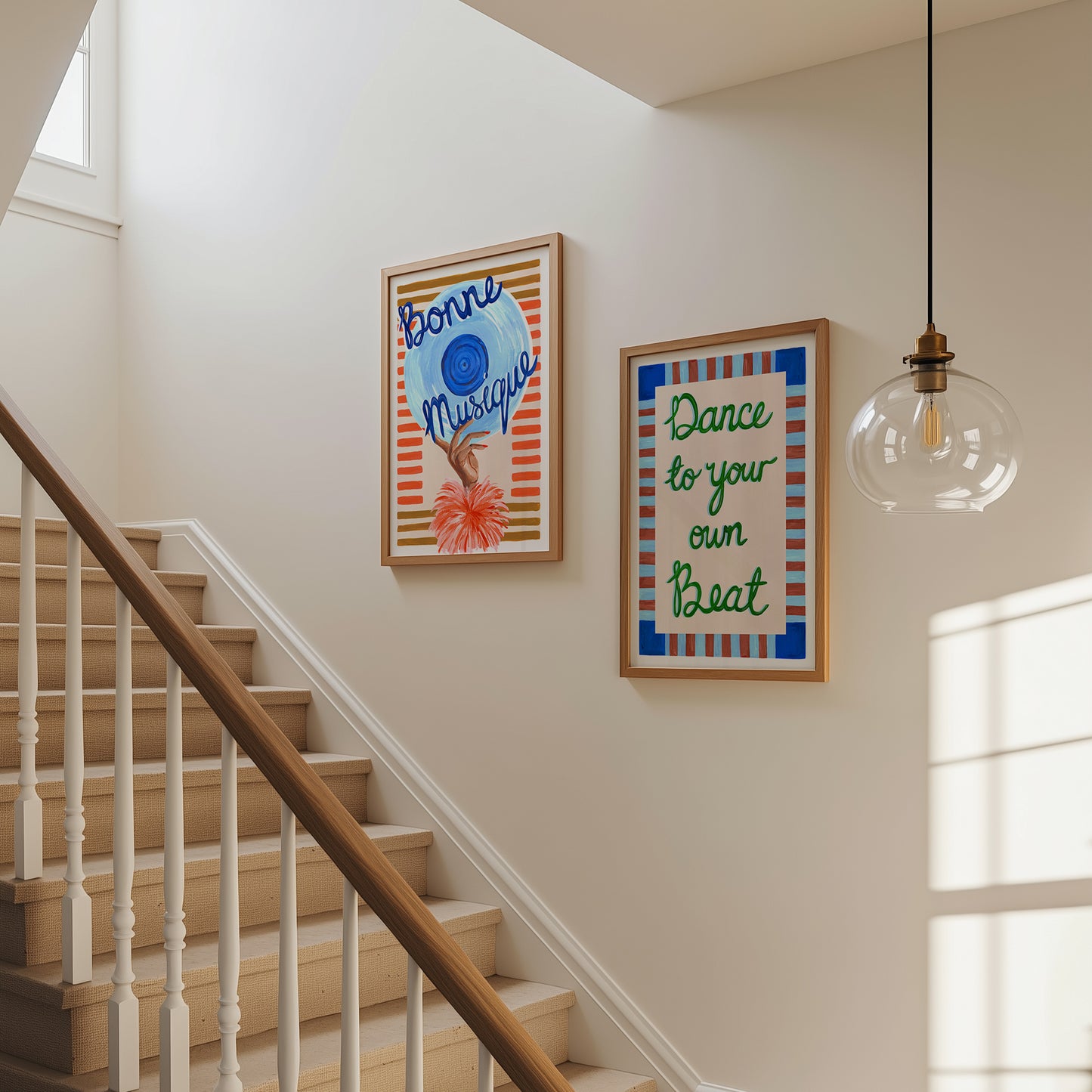 Staircase with framed artwork on a wall, including 'Bonne Musique' and 'Dance to your own Beat' quotes.