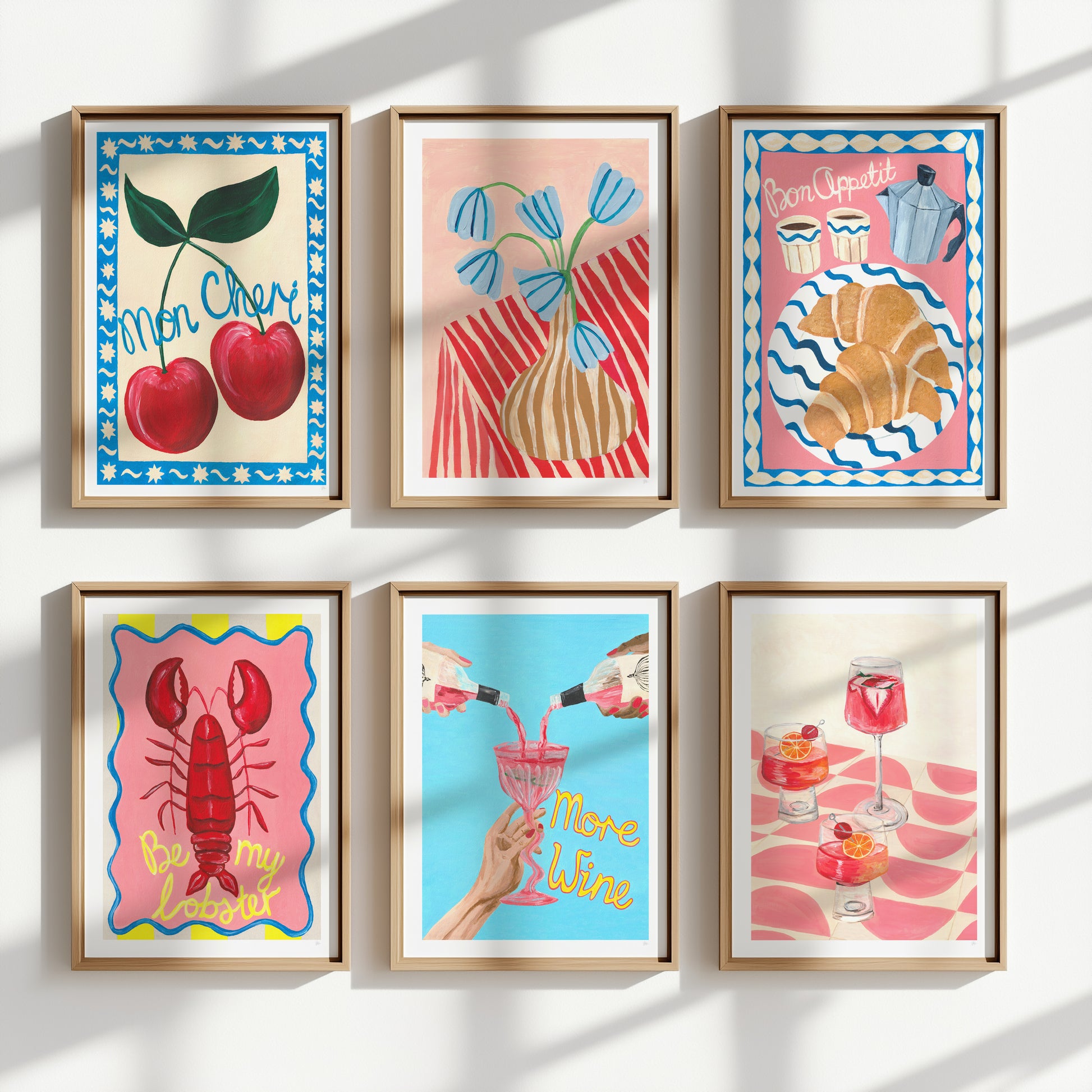 Set of six colorful framed artworks on a white wall