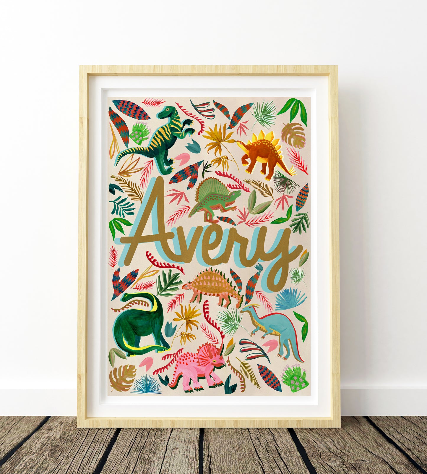 Framed children's poster with colorful dinosaurs and the name 'Avery' on a white background.