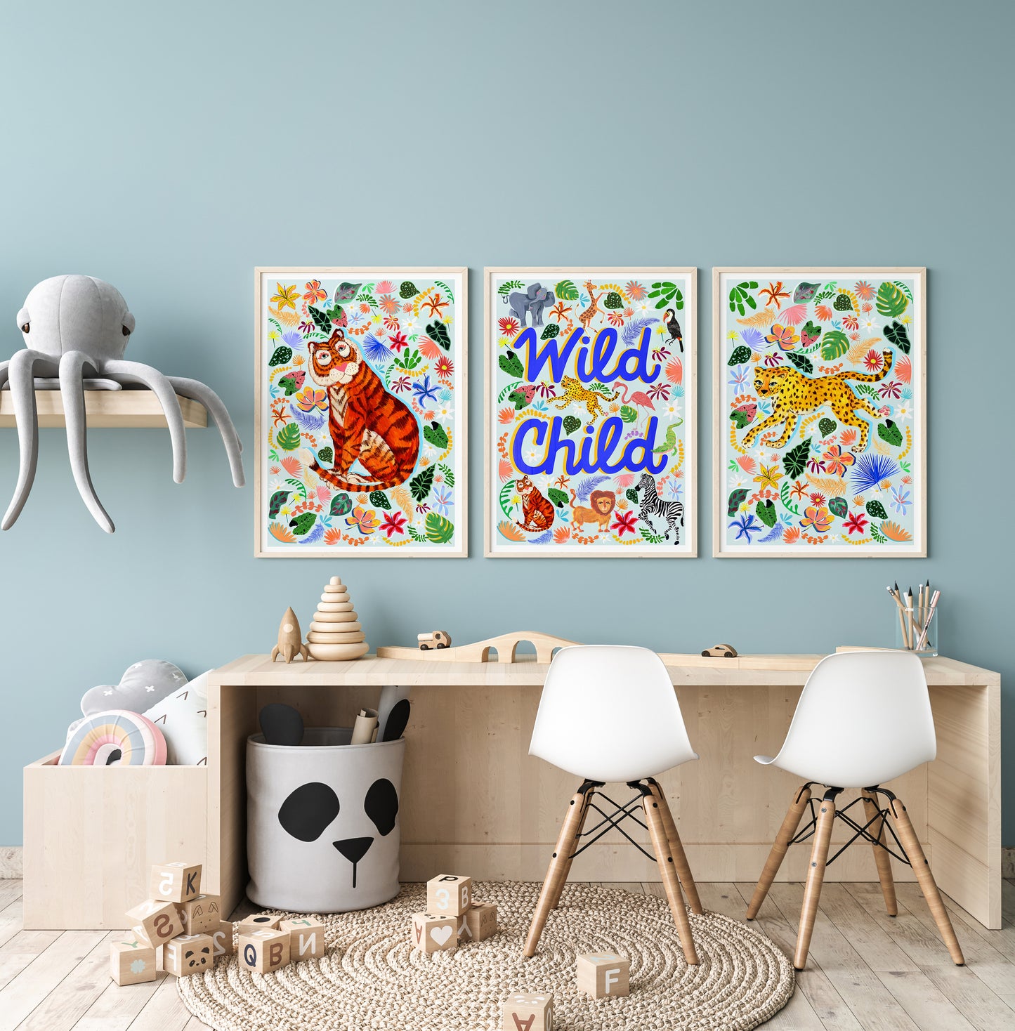 Children's room with colorful wall art, furniture, and toys against a light blue wall.