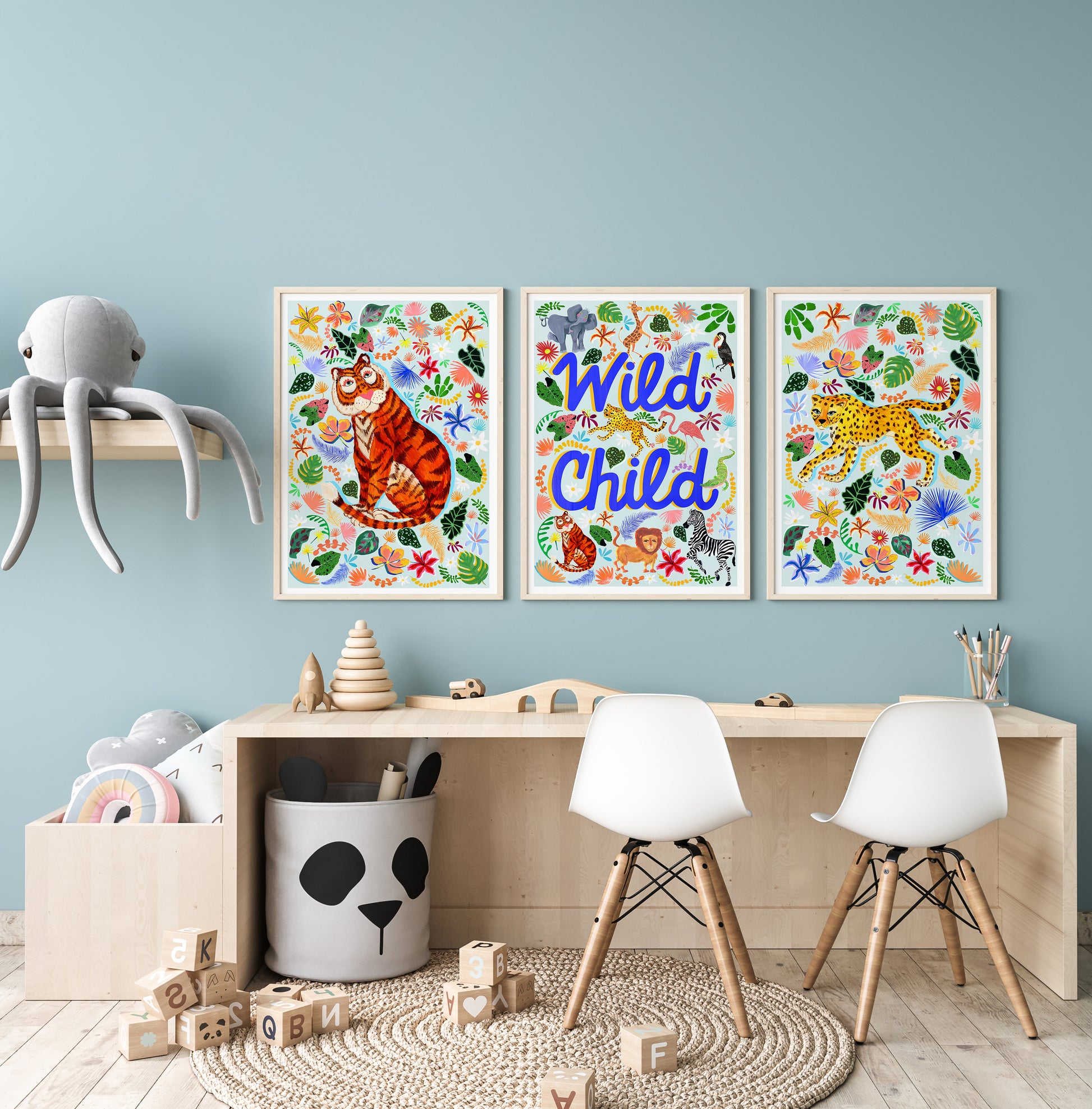 Children's room with colorful wall art, furniture, and toys against a light blue wall.