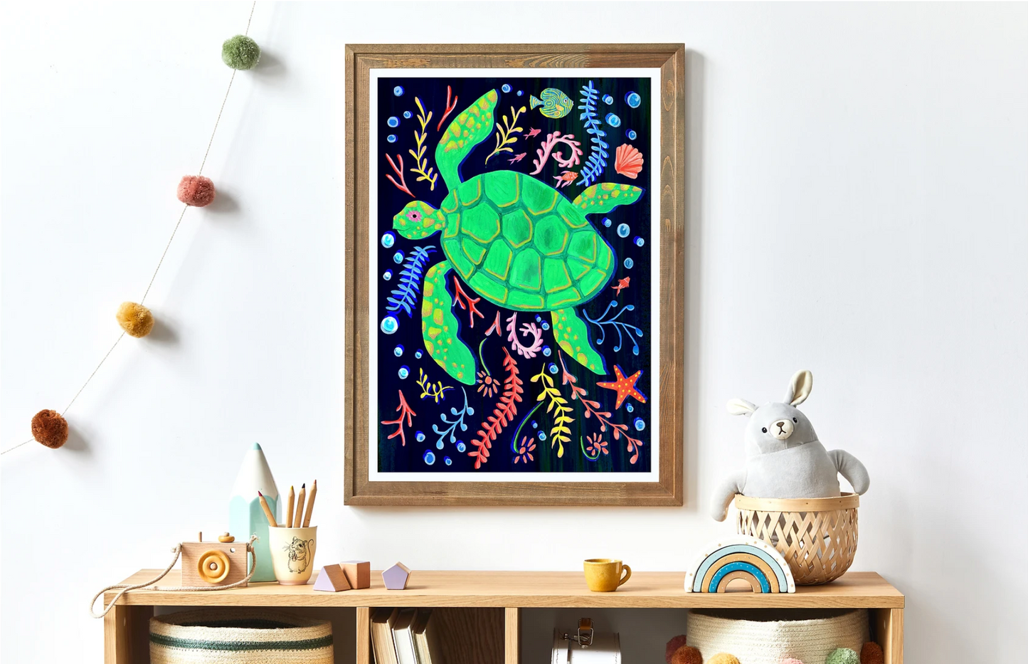Framed artwork of a colorful turtle on a wall above a wooden shelf with decor items.