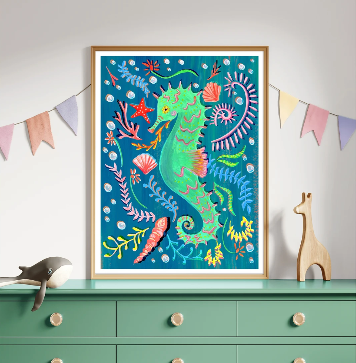 Colorful framed artwork of a seahorse on a green dresser with decorative items.