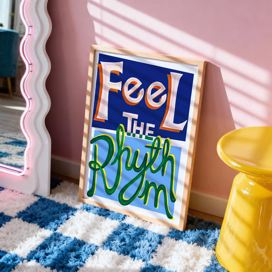 Decorative sign with 'Feel The Rhythm' text in a room with pink walls and a yellow stool.