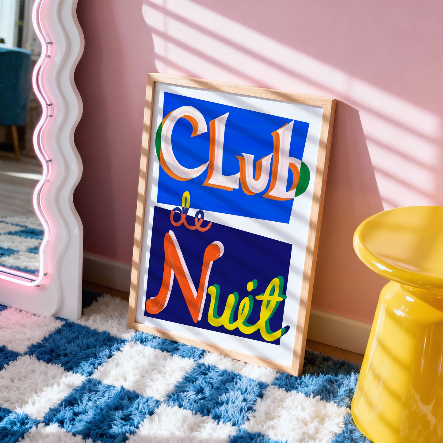 Framed artwork with 'Club de Nuit' text on a checkered floor with a yellow stool and pink wall.
