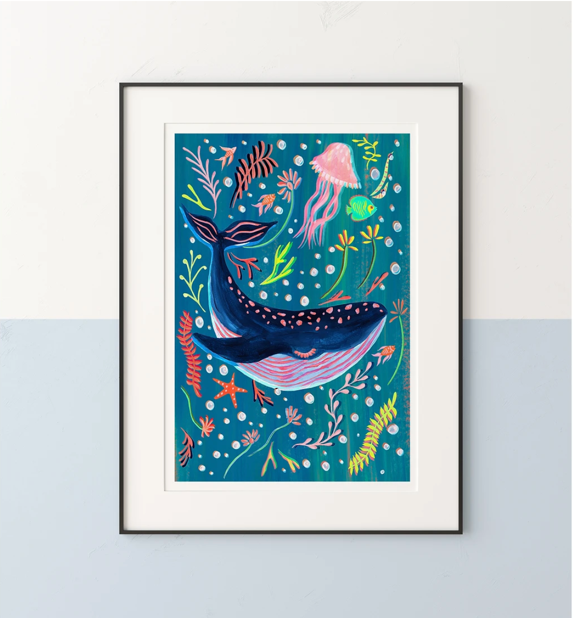 Framed artwork of a whale surrounded by sea creatures on a blue background