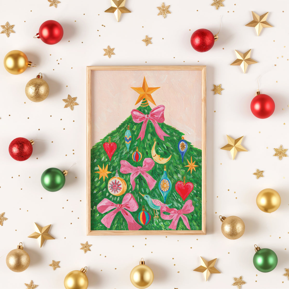 A framed Christmas art print featuring a green tree made of colorful ornaments and pink bows, styled on a white background with scattered gold stars and red, gold, and green ornaments.