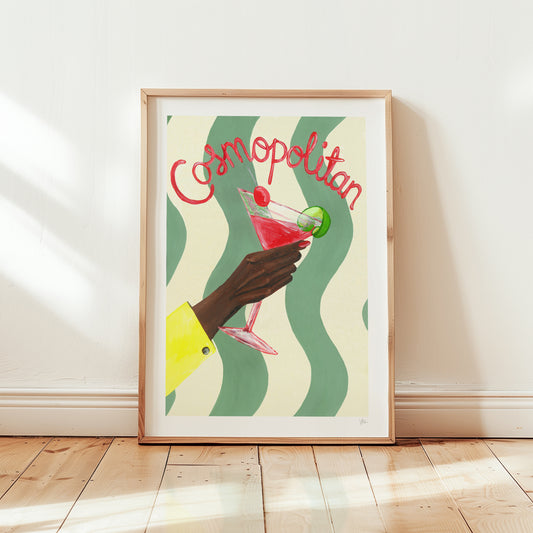 Framed artwork of a hand holding a Cosmopolitan cocktail with wavy green and beige background.