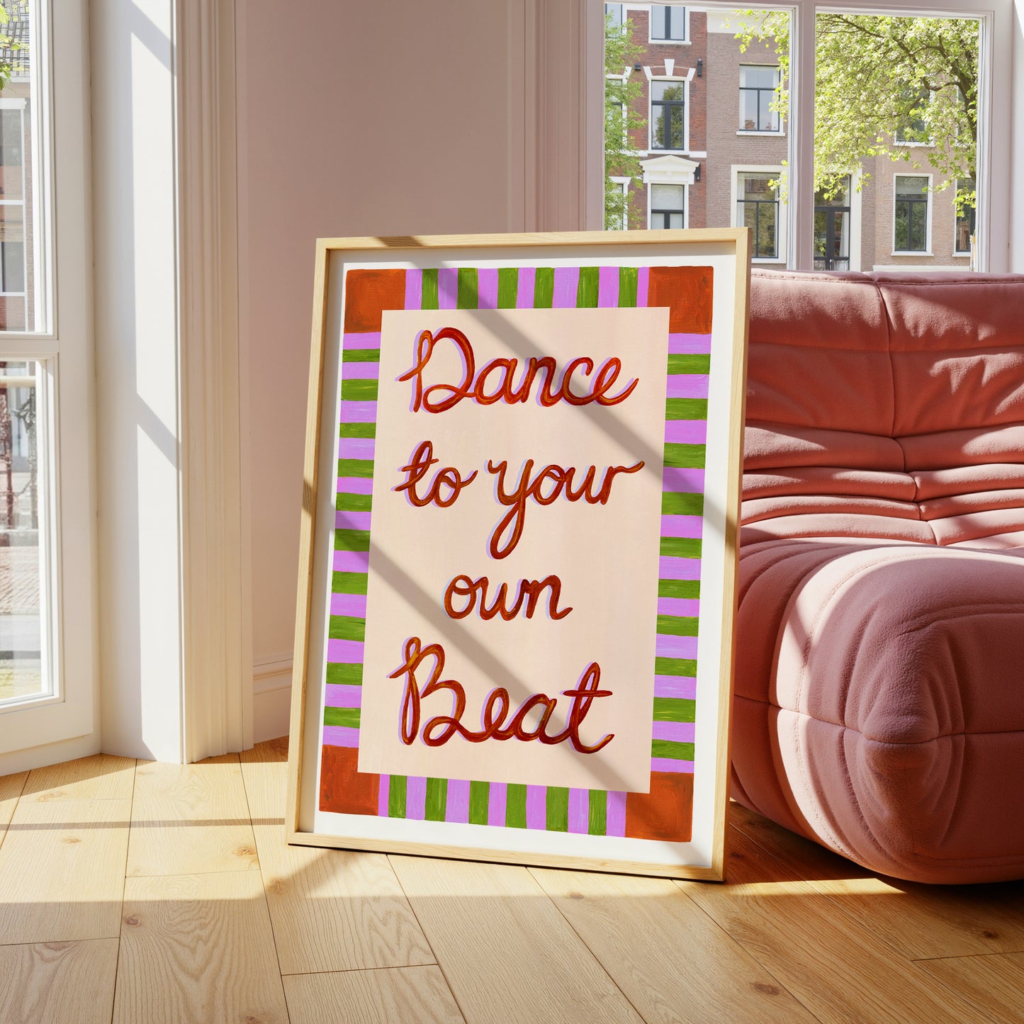 Framed artwork with 'Dance to your own Beat' text in a living room.
