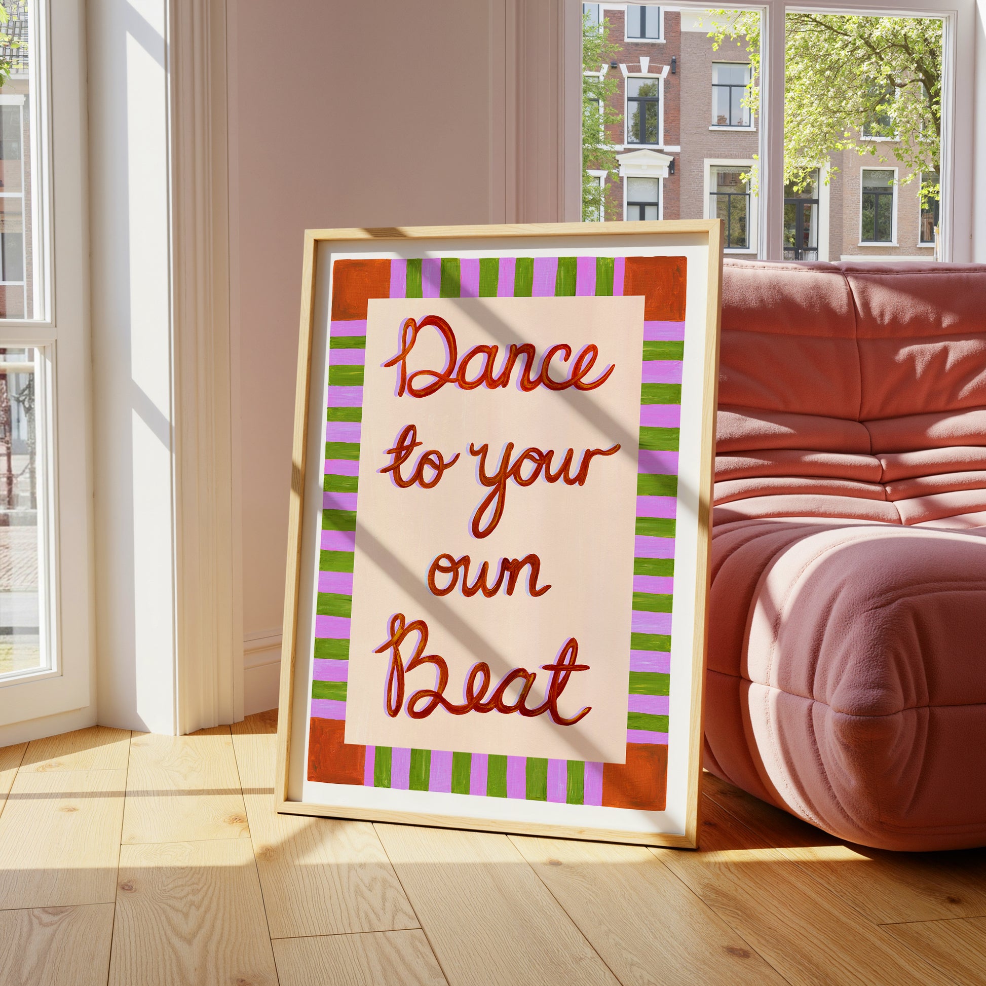 Framed artwork with 'Dance to your own Beat' text in a living room.