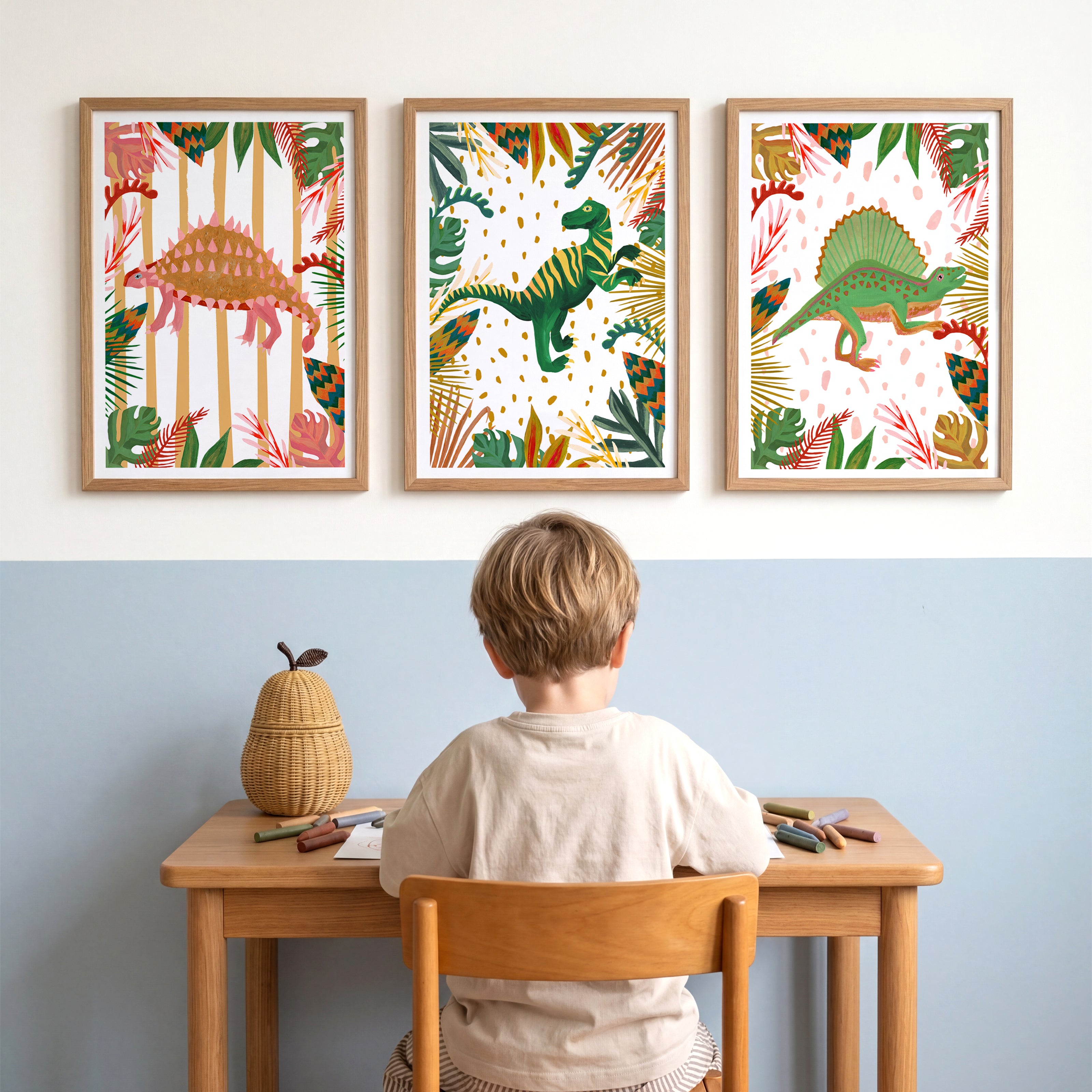 Child sitting at a desk with dinosaur-themed wall art above.