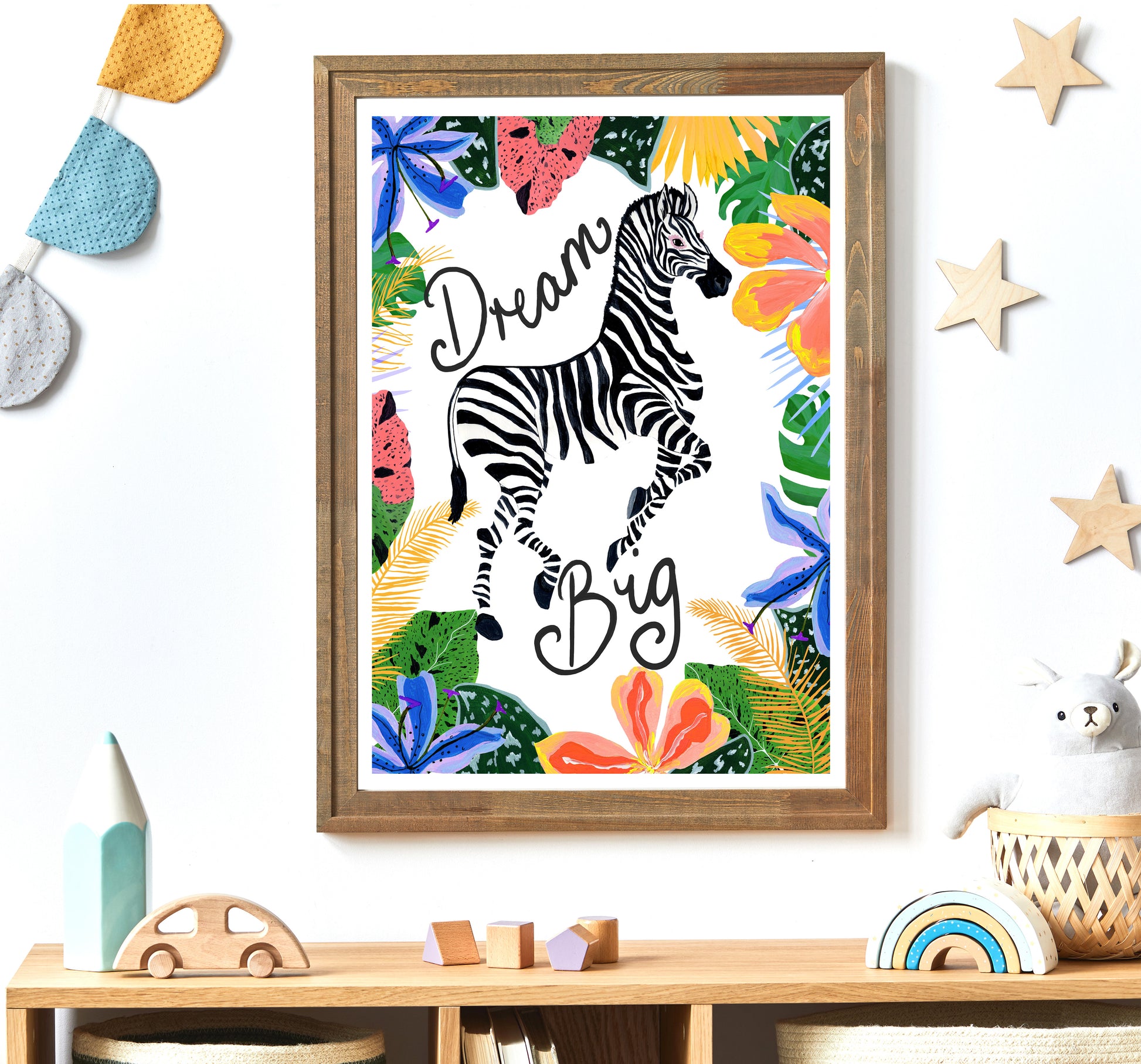 Framed artwork with a zebra and floral design on a wall above a shelf.