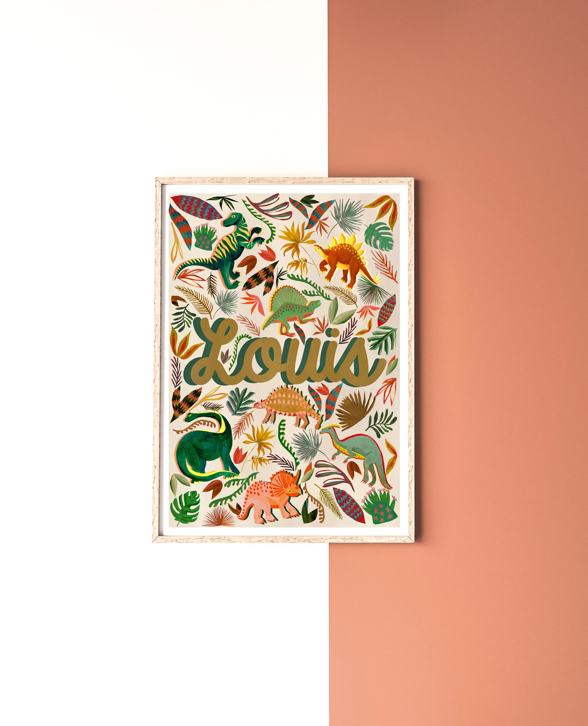 Framed artwork with colorful dinosaur illustrations and the name 'Louis' on a white and pink background.