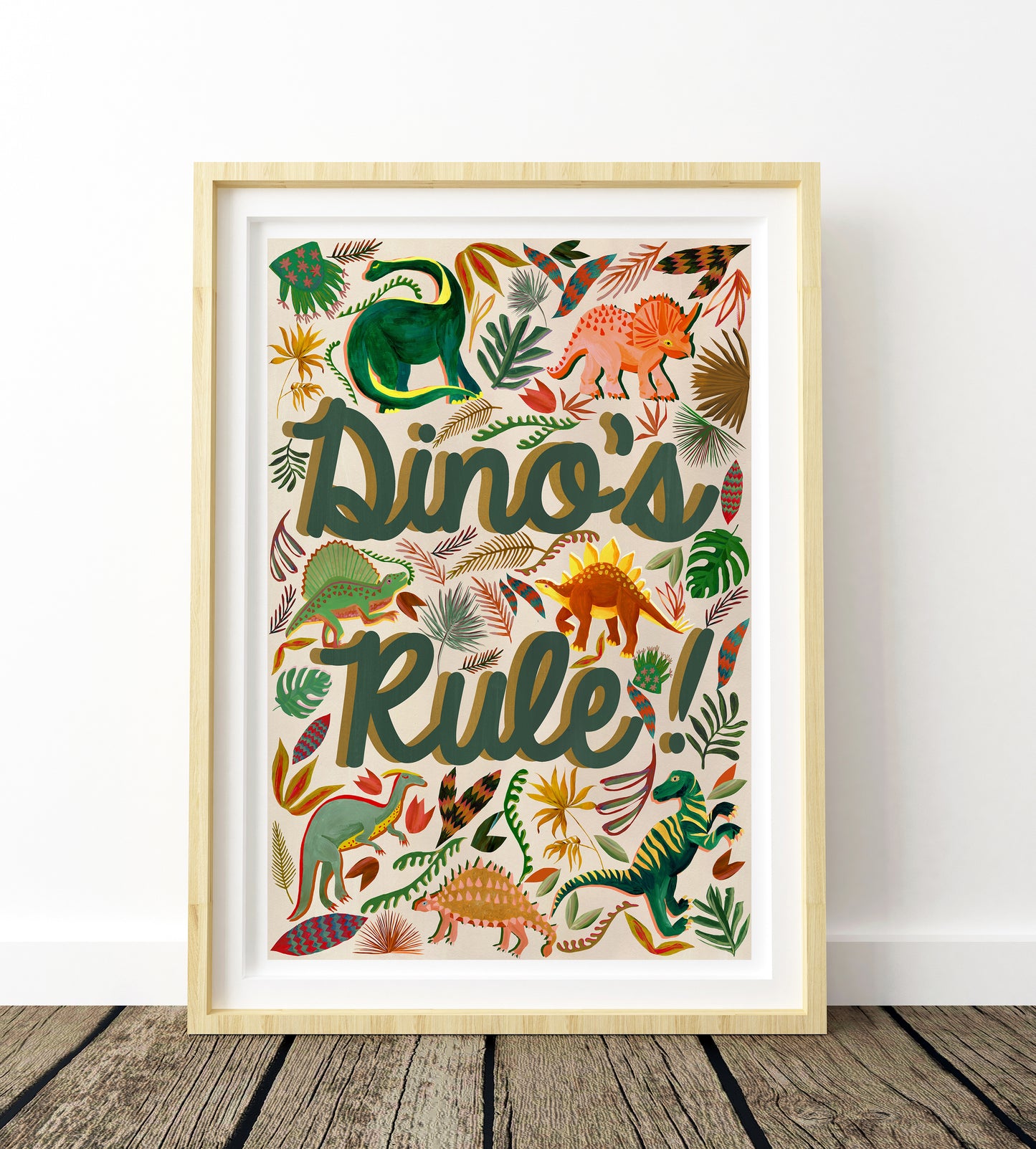 Framed artwork with colorful dinosaur illustrations and 'Dino's Rule!' text on a white wall.