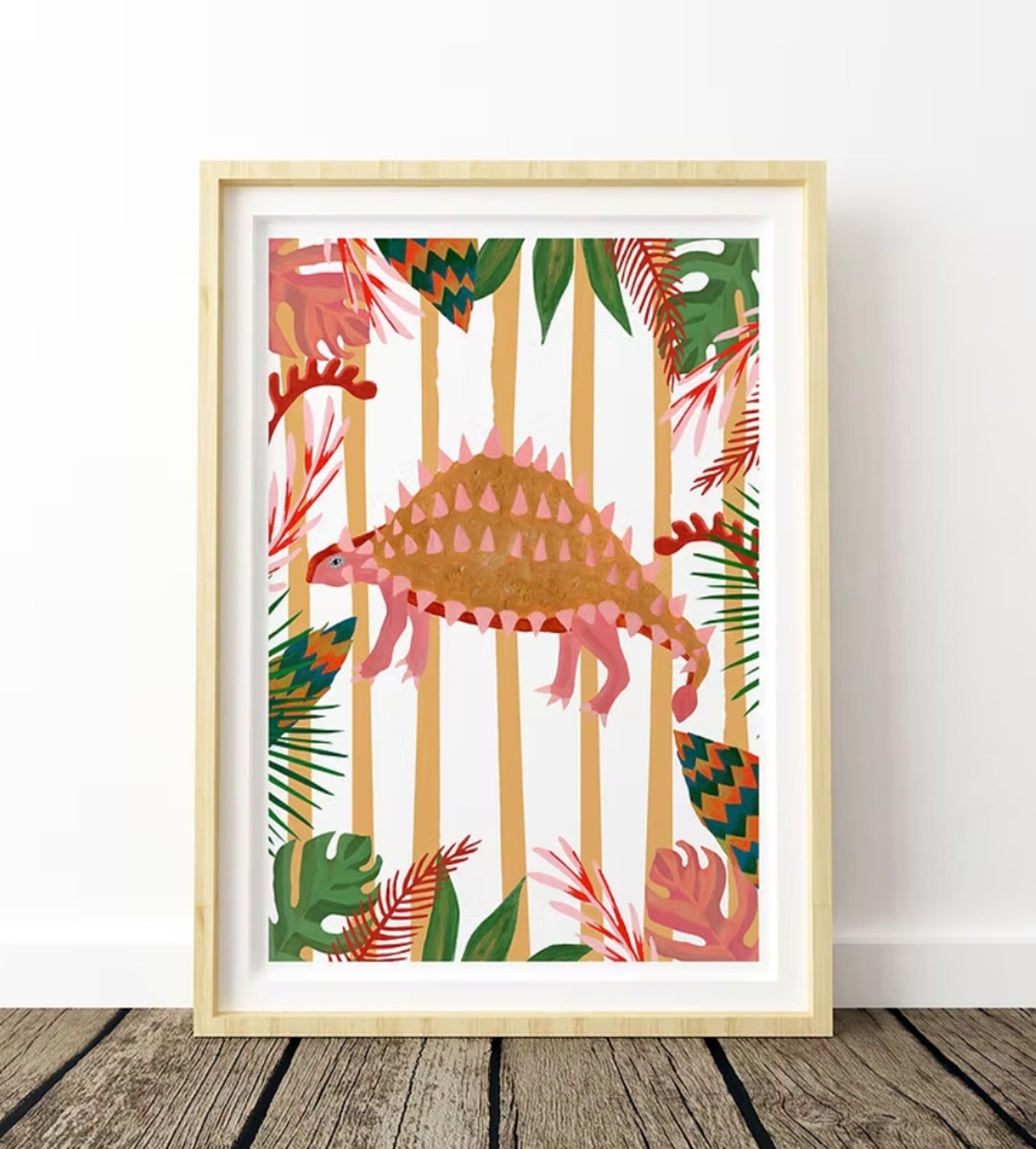 An illustration of an Emontonia Dinosaur with a striped background and colourful tropical leaf boarder in a light wood frame