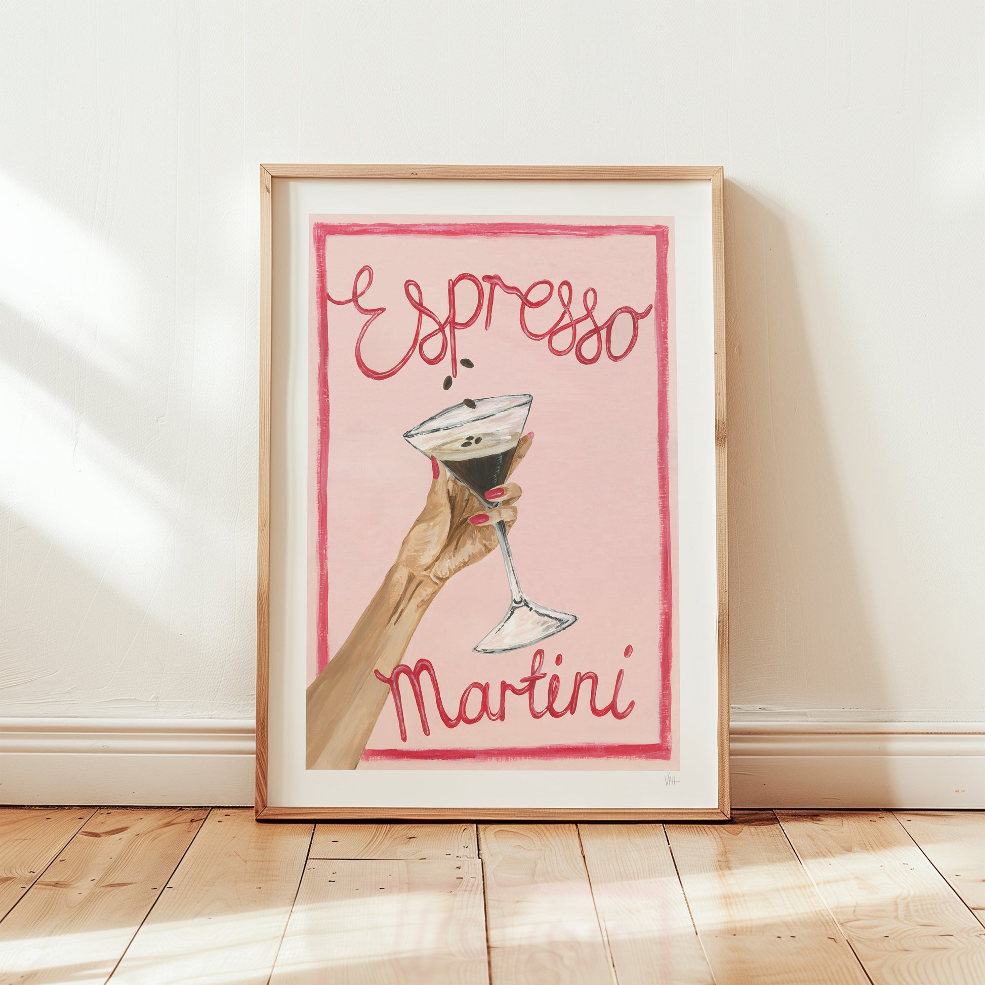 Framed artwork with a hand holding a cocktail and 'Espresso Martini' text on a pink background.